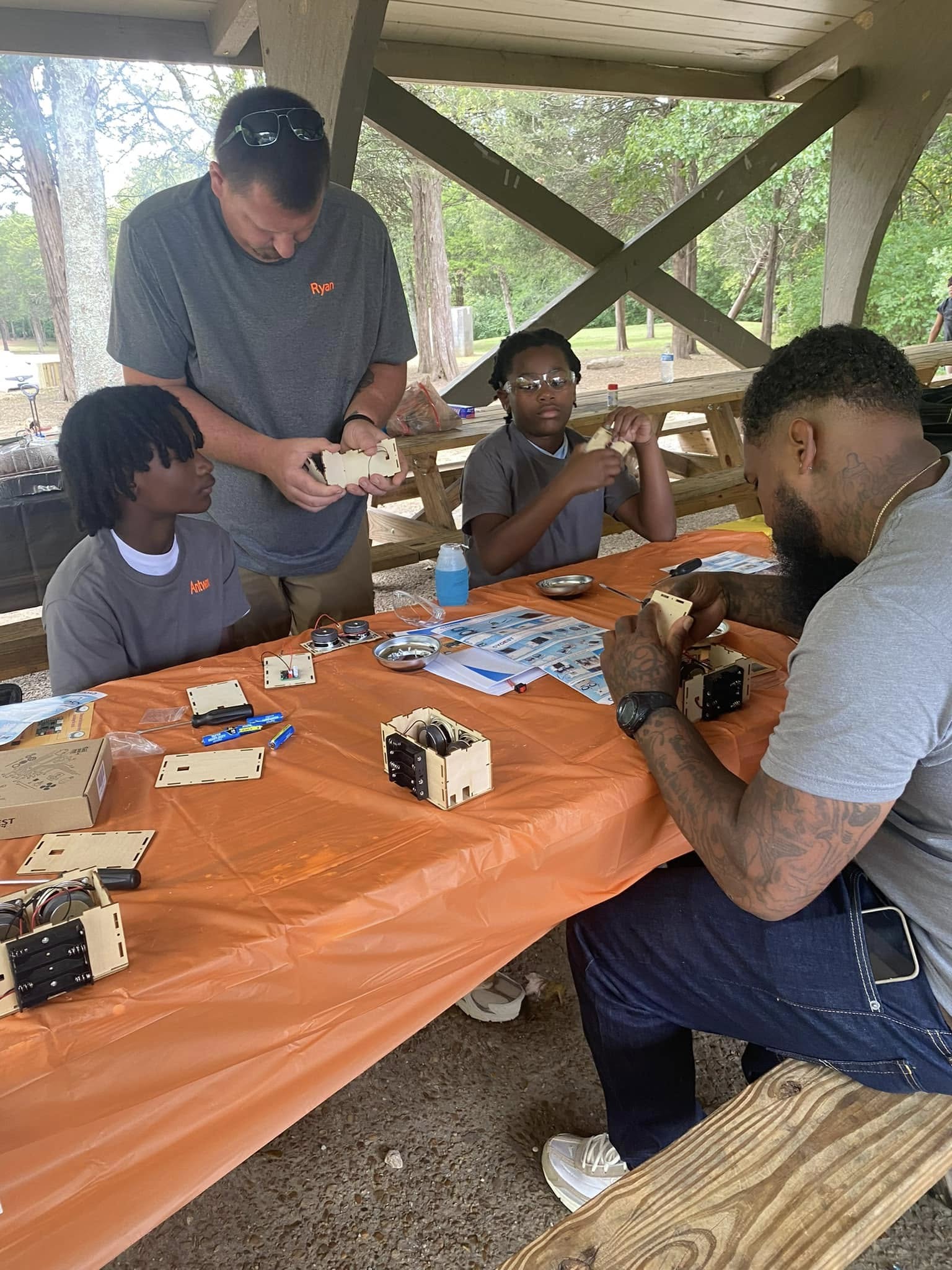 Monte Johnson teaching kids how to build speakers at a Tools for Tomorrow workshop